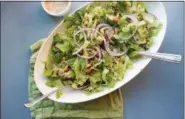  ?? LUCY BENI — ASSOCIATED PRESS ?? This November 2017 photo shows a roasted cauliflowe­r and chickpea salad tossed with garlic-tahini dressing in New York. This dish is from a recipe by Katie Workman.