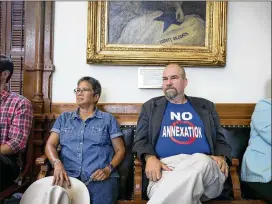  ?? JAY JANNER / AMERICAN-STATESMAN ?? Destinee Serdinia (left) and John Wildenthal, both from Boerne, listen during a Senate Finance Committee hearing at the Capitol on Sunday about the bill that would require a vote of residents in areas considered for annexation.