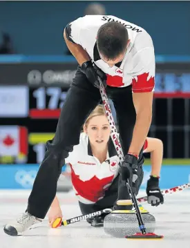  ?? /Reuters ?? Clean sweep: Canada’s Kaitlyn Lawes watches as John Morris works up a sweat as he sweeps during the opening round of the curling event at the Winter Olympics.