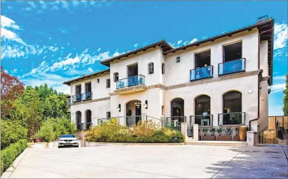  ?? Photog r aphs by Marc Angeles Unlimited Style Real Estate Photog r aphy ?? A GATED driveway approaches the Bel- Air property, leading to a two- story entry with oval windows and wrought- iron accents.