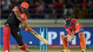  ?? AFP ?? RCB’s Chris Gayle silenced his critics by plundering a 38-ball 77 against Gujarat Lions. —