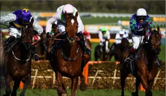  ??  ?? Monkfish, with Paul Townend up (centre), on their way to winning the Albert Bartlett Novices’ Hurdle ahead of runner-up Latest Exhibition, with Brian Cooper up (left), and Thyme Hill, with Richard Johnson up, on day four.