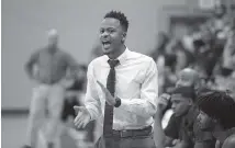  ?? STAFF PHOTO BY DOUG STRICKLAND ?? Tyner basketball coach E’jay Ward directs players during their game Friday at Chattanoog­a School for the Arts and Sciences.