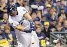  ?? MATT SLOCUM/ASSOCIATED PRESS ?? Milwaukee’s Jesus Aguilar hits an RBI single in the eighth inning that boosted the Brewers’ lead to 7-2 in their Game 6 victory Friday.