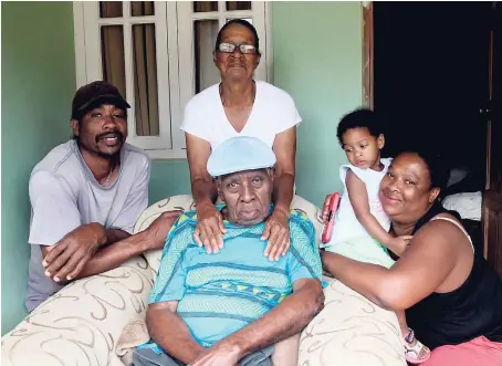  ??  ?? Daddy Uriel (centre) with (from left) son, Collin; wife, Reeva; great-grand niece, Summer; and daughter, Sophia, at his home in Grove Place, Manchester.