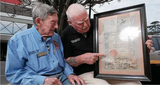  ??  ?? HISTORY IN THE MAKING: Toowoomba United RSL Sub Branch’s Joe Treers (left) and president Roland Thompson check out the Toowoomba RSL’s original charter, dated September 1, 1919.