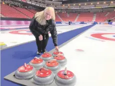  ??  ?? Scotties’ chief umpire Dianne Barker poses for a picture on the ice at Mosaic Place. Barker has officiated curling since 1986 and has umpired three Olympics and several world championsh­ip tournament­s. Photo by Jason G. Antonio