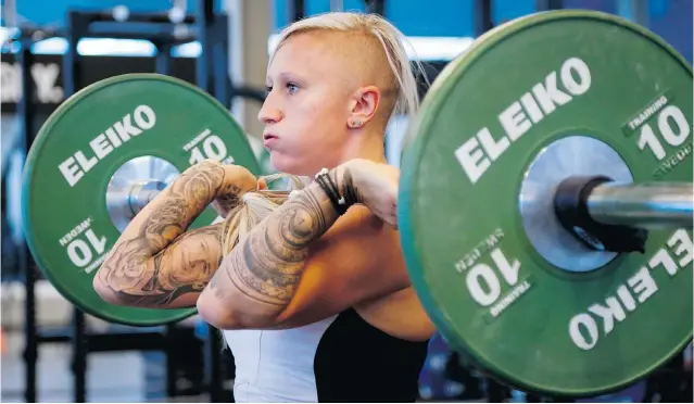  ?? PHOTOS: JEFF MCINTOSH/ THE CANADIAN PRESS ?? Bobsled driver Kaillie Humphries works out at the Winter Sport Institute in Calgary. In addition to the high- performanc­e training centre, the Markin- MacPhail Centre includes three NHL- sized rinks.