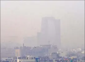  ?? SUNIL GHOSH/HT PHOTO ?? A view of a highrise buildings in Noida is marred by the haze on Thursday morning. Weather experts say the pollution level will persist for a few days.