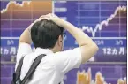  ?? KOJI SASAHARA — THE ASSOCIATED PRESS ?? Asian shares were lower Monday on investor jitters from a North Korean nuclear test.