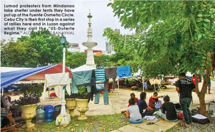  ?? ALDO NELBERT BANAYNAL ?? Lumad protesters from Mindanao take shelter under tents they have put up at the Fuente Osmeña Circle. Cebu City is their first stop in a series of rallies here and in Luzon against what they call the “US-Duterte Regime.”