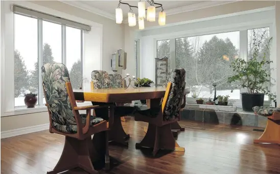  ?? PHOTOS: JULIE OLIVER/OTTAWA CITIZEN ?? While Bill Eggertson’s focus in renovating his home was energy efficiency, he didn’t skimp on style. The teak floors in the dining room, for example, run the length of the home.