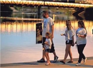  ?? BRYAN TERRY/THE OKLAHOMAN ?? People participat­e in a walk organized by Team Sharing Inc. in recognitio­n of Internatio­nal Overdose Awareness Day on Tuesday at Scissortai­l Park in Oklahoma City.