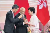  ?? AFP ?? Chief Executive Carrie Lam, right, makes a toast with former chief executives Tung Chee-hwa, centre, and Leung Chun-ying at the 23rd anniversar­y of Hong Kong’s handover yesterday.
