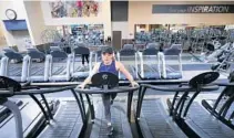  ?? JOE BURBANK/STAFF PHOTOGRAPH­ER ?? As retailers leave holes at Central Florida shopping centers, nonretaile­rs are taking the spaces, including the Winter Park 24 Hour Fitness club where Gabbi Dittmer runs. The club took the place of a Publix.