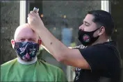  ??  ?? A community member gets his head shaved during “Woodland Shaves,” an event put on by the St. Baldrick’s foundation.