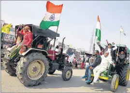  ?? ANI ?? Farmers arrive on tractors to take part in a protest against the farm laws, at Singhu Border, in New Delhi on Saturday.