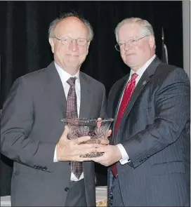  ?? — GRAND RAPIDS LEGAL NEWS FILES ?? Environmen­tal lawyer Jim Olson, left, accepts the State Bar of Michigan’s Champion of Justice award from State Bar president Charles Toy in September 2010.