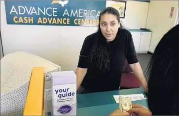  ?? Rick Loomis Los Angeles Times ?? ADVANCE AMERICA will pay fines and refunds of $160,000 to settle allegation­s that it charged illegally high interest rates topping 100%. Above, Sadia Garcia at an Advance America branch in Los Angeles.