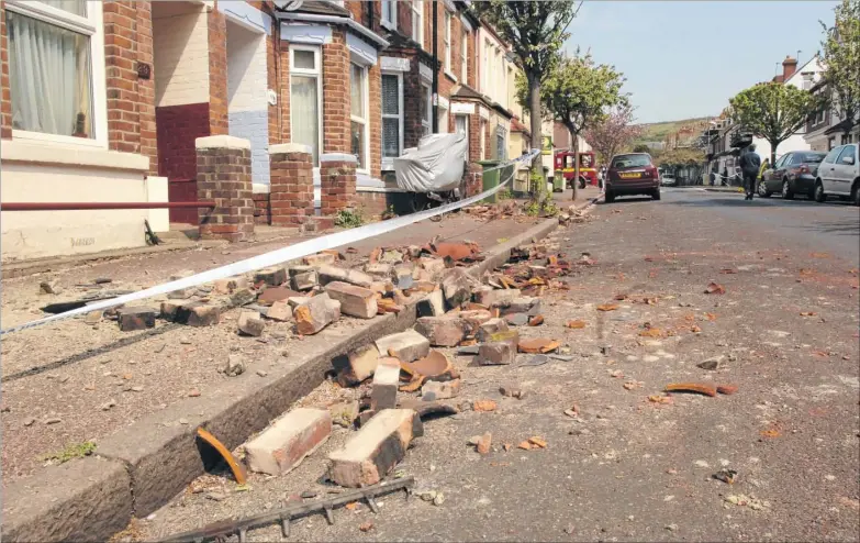  ??  ?? Fallen chimney stacks and brickwork lays across the street after an earthquake, registerin­g a magnitude of 4.3, hit Folkestone at 8.20am on Saturday, April 28, 2007 – 10 years ago