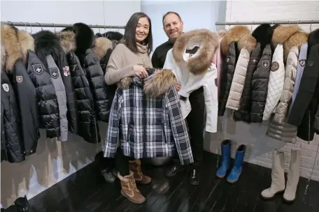  ?? ANGELA ROWLINGS PHOTOS / HERALD STAFF ?? HIGH-END COATS: Miyuki Tachibana and Mark Miller are seen recently with some of their M. Miller ski jackets at their South End store.