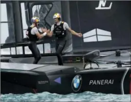  ?? GREGORY BULL — THE ASSOCIATED PRESS ?? Oracle Team USA skipper and helmsman Jimmy Spithill, left, celebrates with teammate wing trimmer Kyle Langford after winning the sixth race of America’s Cup sailing competitio­n against Emirates Team New Zealand Saturday in Hamilton, Bermuda.