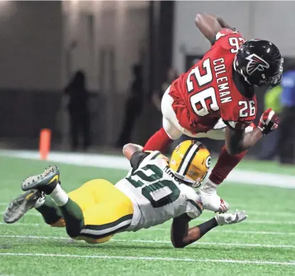  ?? RICK WOOD / MILWAUKEE JOURNAL SENTINEL ?? Falcons running back Tevin Coleman is pulled down for no gain by Packers cornerback Kevin King. If the Packers are going to make a splash on defense, the rookies may have to play more.