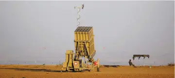  ?? (Amir Cohen/Reuters) ?? A SOLDIER keeps watch near an Iron Dome battery deployed near the central Gaza Strip in October.