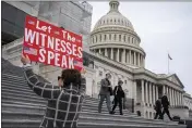  ?? J. SCOTT APPLEWHITE — THE ASSOCIATED PRESS ?? Laura Albinson of Pasadena, Md., displays a message for members of the House as they leave the Capitol in Washington on Friday.