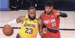  ??  ?? LeBron James drives against Carmelo Anthony during Game 2 of the Lakers-Trail Blazers first-round playoff series.