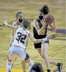  ?? Helen H. Richardson, The Denver Post ?? Mullen’s Gracie Gallegos tries to drive past Windsor’s Samantha Darnell (32) during the second half Sunday at the Broadmoor World Arena in Colorado Springs.