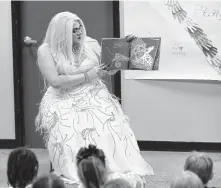  ?? Karen Warren / Staff photograph­er ?? Tatiana reads to children during the Drag Queen Story Time at Freed-Montrose Neighborho­od Library on Sept. 29. A lawsuit filed Friday says the event is not not appropriat­e for all patrons.