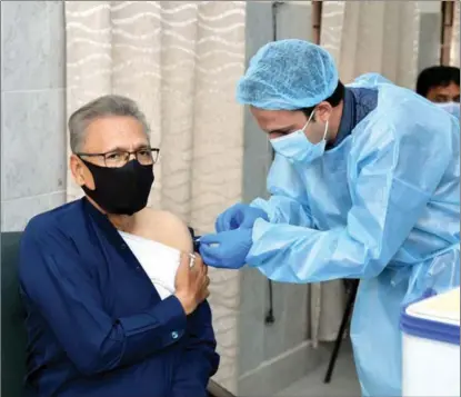  ?? XINHUA ?? Pakistani President Arif Alvi receives a shot of COVID-19 vaccine, in Islamabad, on March 15.