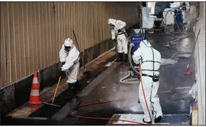  ?? The New York Times/DMITRY KOSTYUKOV ?? Workers clean up a lead-contaminat­ed area near Notre Dame Cathedral in Paris on Sept. 2. The fire April 15 at the cathedral spread clouds of lead dust that officials were slow to deal with, an investigat­ion shows.