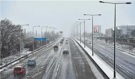  ??  ?? Frosty day: Motorists travelling on a snowy afternoon along a highway on the outskirts of London. — AFP