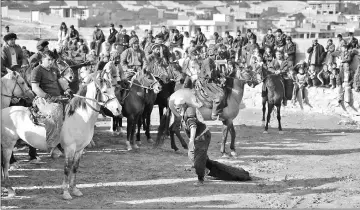  ??  ?? A referee dragging the carcass of a goat before the start of a game.