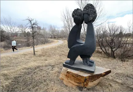  ?? JENNY SPARKS — LOVELAND REPORTER-HERALD ?? Andrew Kaplan walks past a sculpture at Chapungu Sculpture Park on Tuesday at Promenade Shops at Centerra in east Loveland.