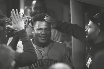  ?? WINSLOW TOWNSON/AP ?? HOUSTON ASTROS STARTING PITCHER FRAMBER VALDEZ CELEBRATES in the dugout after the eighth inning in Game 5 of the American League Championsh­ip Series against the Boston Red Sox Wednesday in Boston.