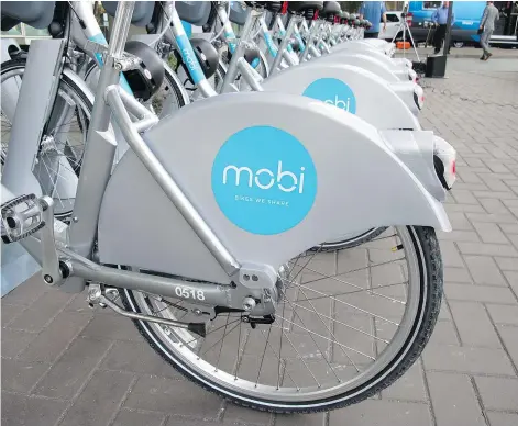  ?? — MICHAEL MUI/24 HOURS FILES ?? Vancouver’s Mobi bike share system was just launched last month but is already drawing more riders per bike, per day, than the six-month-old Seattle bike-share program.