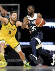  ?? ANDY BROWNBILL - THE ASSOCIATED PRESS ?? Australia’s Matthew Dellavedov­a, left, and United States’ Kemba Walker in action during their exhibition basketball game in Melbourne, Saturday, Aug. 24, 2019.