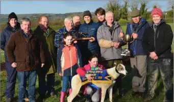  ??  ?? Walther Costello and James Costello presenting the cups to Jack and Tom Flaherty and Syndicate members after Tom’s dog, Gandard Gust, won the Derby Trial Stakes at Castleisla­nd Coursing