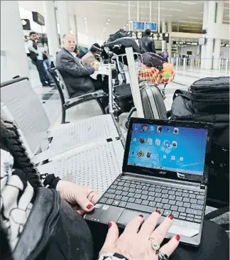  ??  ?? Una mujer navega en su ordenador en el aeropuerto de Beirut