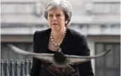  ?? — AFP ?? A pigeon flies as Britain’s Prime Minister Theresa May arrives to attend a memorial service at St. Martin- intheField­s in Trafalgar Square in London last week to commemorat­e the 25th anniversar­y of the murder of Stephen Lawrence.
