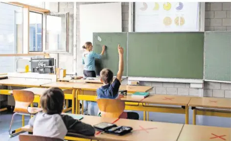  ??  ?? In kleinen Gruppen sollen die Schüler samstags, alternativ in der Woche nachmittag­s, Lernrückst­ände aufarbeite­n können.
FOTO: PHILIPP VON DITFURTH/DPA