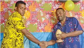  ??  ?? Henry Smith receives his award from Nayavuloul­ou Methodist Church senior member, Jone Lewa on Friday. Photo: Anasilini Ratuva