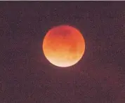  ??  ?? The super blue blood moon turns red as it enters Earth’s shadow early Wednesday.