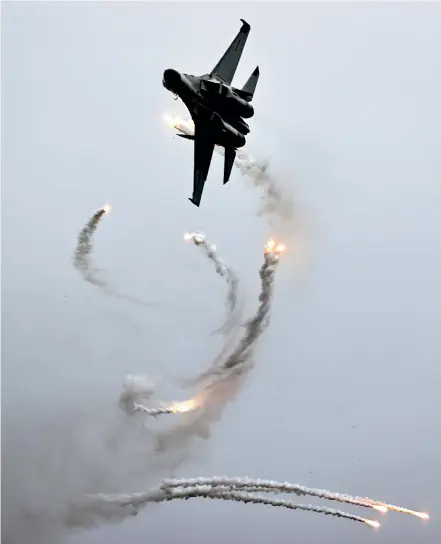  ?? GETTY IMAGES ?? A J-11BS fighter jet releases decoy flares during and air show in Jilin Province of China.