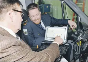  ?? HEATHER TAWEEL/THE GUARDIAN ?? Dr. Scott Cameron, foreground, chairman of the emergency medical services board, says the new Computer Assisted Dispatch (CAD) software will be installed in all ambulances across P.E.I. CAD tracks ambulances and will be used to create data that will...