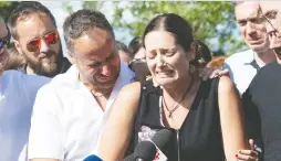  ?? JACQUES BOISSINOT/ THE CANADIAN PRESS FILES ?? Amélie Lemieux is comforted by family members as she speaks about her two daughters, Romy and Norah Carpentier, at a memorial for the girls in Lévis in July.