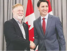  ?? JACQUES BOISSINOT/CP ?? Prime Minister Justin Trudeau, right, meets with Laval Mayor Marc Demers at the Federation of Canadian Municipali­ties annual conference Friday in Quebec City.